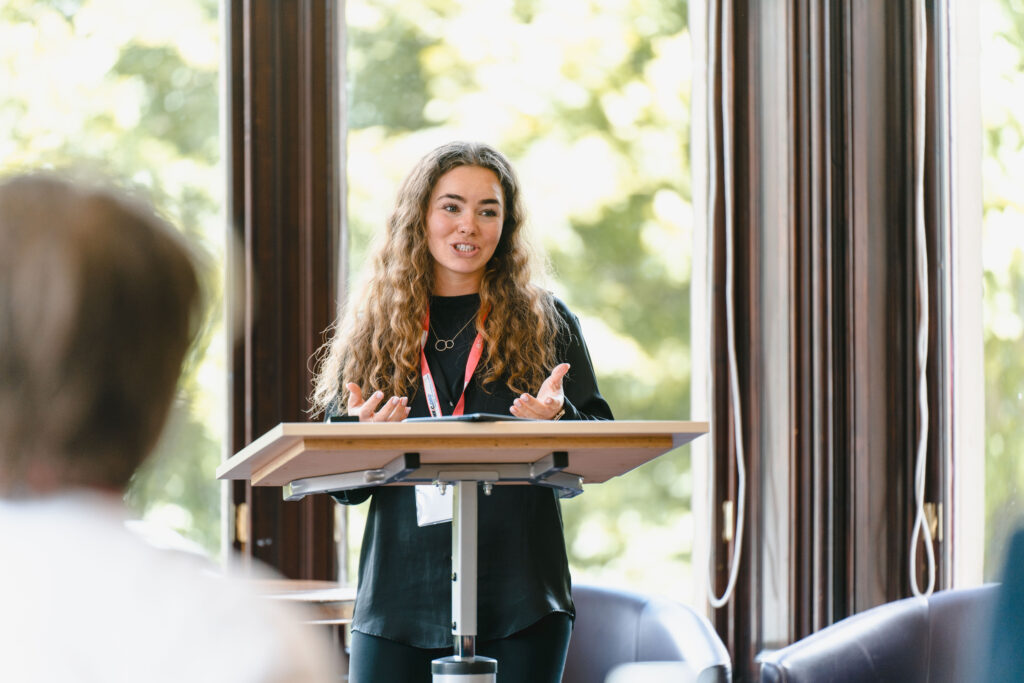 An early-career researcher delivering her presentation