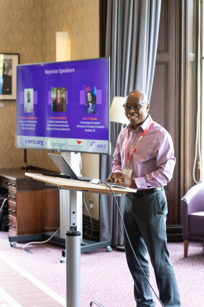 A senior academic sharing his research with the audience